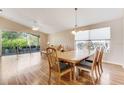 Bright dining area with hardwood floors, a ceiling fan, and sliding glass doors to the lanai at 915 Ashmeade Ct, Port Orange, FL 32127