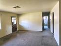 Open living room featuring carpet flooring, and bathroom entrance at 1040 Ne 25Th St, Ocala, FL 34470