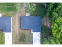 Drone shot highlighting the roof and proximity to neighbor, the driveway, and natural surroundings at 18 Malauka Loop Pass, Ocklawaha, FL 32179