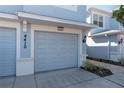 View of the garage, painted gray, with a light and the house number displayed at 4410 Sw 52Nd Cir # 108, Ocala, FL 34474