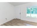 Bright entryway with modern vinyl floors and a view of the yard at 61 Fisher Way Crse, Ocklawaha, FL 32179