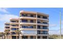 Coastal multi-story condo building showcasing a light stucco exterior, balconies, and ocean views at 3370 Ocean Shore Blvd # 5020, Ormond Beach, FL 32176