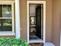 Warm, welcoming home entryway showcasing stylish door, complementary decor, and neutral tones that enhance a cozy atmosphere at 5108 Caspian St, St Cloud, FL 34771