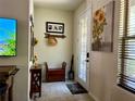 Inviting entryway featuring decorative accents, functional bench seating, and abundant natural light through the window at 5108 Caspian St, St Cloud, FL 34771
