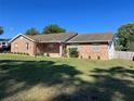 Charming brick home featuring a well-manicured lawn and inviting front entrance at 3295 Se 56Th Ave, Ocala, FL 34480