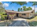 Inviting brick home featuring a convenient carport and lush, green landscaping at 8082 Sw 103Rd Ln, Ocala, FL 34481