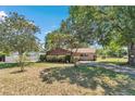A well-manicured front yard with lush landscaping surrounding a charming home at 8082 Sw 103Rd Ln, Ocala, FL 34481