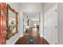 Elegant entryway featuring hardwood floors and a decorative mirror, leading to the living spaces at 9945 Sw 55Th Avenue Rd, Ocala, FL 34476