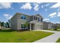 Charming two-story home with a well-manicured lawn and attached two-car garage at 6683 Se 3Rd Loop, Ocala, FL 34472