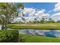 Beautiful golf course view with a pond and blue skies with white clouds reflecting in the water at 1882 Royal Lytham Ct, Port Orange, FL 32128