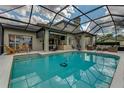 Enjoy the outdoors with this large screened-in pool and beautiful outdoor seating and bar area at 1882 Royal Lytham Ct, Port Orange, FL 32128