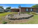 Manicured front yard with lovely rock garden and a lamp post enhance the curb appeal of this brick house at 2030 Se 32Nd Ln, Ocala, FL 34471