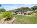 Spacious backyard with manicured landscaping, including shrubs and stone accents at 7274 Sw 95Th Ave, Ocala, FL 34481
