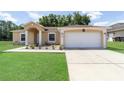 Lovely one-story home boasting a two-car garage and a beautifully maintained front yard at 2648 Ne 24Th Pl, Ocala, FL 34470
