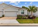 Attractive home with a neutral exterior, brick-paved driveway and manicured landscaping at 5237 Nw 48Th Pl, Ocala, FL 34482