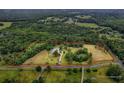 Aerial shot showcasing the estate's vast land, surrounded by lush greenery and trees at 20250 Nw 71St Ct, Micanopy, FL 32667