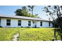 Well-maintained single-story home featuring a bright white exterior and green lawn at 251 Celery Cir, Oviedo, FL 32765