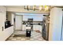 Spacious kitchen with white cabinetry, stainless steel appliances, and modern lighting at 251 Celery Cir, Oviedo, FL 32765