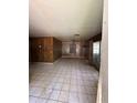 Spacious living room featuring tile flooring, wood paneling and a ceiling fan at 15750 Ne 150Th Ter, Fort Mc Coy, FL 32134