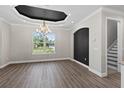 Spacious dining area features modern wood flooring, neutral walls, and a large window overlooking the front yard at 17781 Sw 72Nd Street Rd, Dunnellon, FL 34432