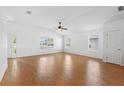 Bright living room featuring tile floors, multiple windows, and a ceiling fan at 2297 Montbrook Pl, The Villages, FL 32162