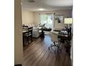 Open-concept living room features wood floors, a sliding glass door, and comfortable furniture at 3875 Shaftbury Pl, Oviedo, FL 32765