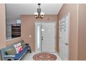 Traditional entryway featuring tile flooring, a bench, and coat rack for a welcoming and organized space at 3968 Sw 131St Place Rd, Ocala, FL 34473