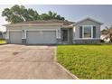 Charming single-story home featuring a three-car garage and well-maintained lawn at 4261 Sw 62Nd Loop, Ocala, FL 34474
