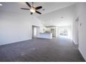 Bright, open-concept living space with gray vinyl floors, flowing into the kitchen and dining area at 8881 Sw 138Th Ln, Ocala, FL 34473