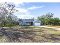 Spacious single-Gathering home on a sprawling lot surrounded by lush greenery and a long driveway at 8900 Sw 138Th Ln, Ocala, FL 34473