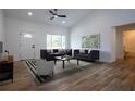 Bright living room featuring modern decor, hardwood floors, neutral paint, and ample natural light at 8900 Sw 138Th Ln, Ocala, FL 34473