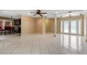 Open-concept living area with tile flooring, decorative columns, and lots of natural light at 2135 Se 12Th St, Ocala, FL 34471