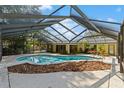 A sparkling screened-in pool is surrounded by a large deck perfect for outdoor entertaining at 2135 Se 12Th St, Ocala, FL 34471