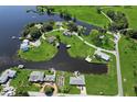 Aerial view of homes along the water with grassy lawns and mature trees create a serene and picturesque setting at 3943 Nw 219Th Street Rd, Micanopy, FL 32667