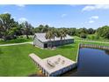 Stunning aerial view of house with a private dock with an outdoor seating area on waterfront property at 3943 Nw 219Th Street Rd, Micanopy, FL 32667