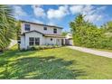 Charming two-story home with a landscaped lawn and a driveway leading to the front entrance at 716 Golfview St, Orlando, FL 32804