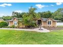 Beautiful single-story home with a well-manicured lawn and a lovely fountain in the front yard at 5005 Se 47Th Terrace Rd, Ocala, FL 34480