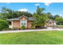 This home has lush green grass and landscaping, with a walkway and a fountain in the front yard at 5005 Se 47Th Terrace Rd, Ocala, FL 34480