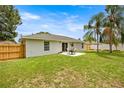 Spacious backyard with patio table and chairs set for outdoor entertaining at 680 Nw 67Th Pl, Ocala, FL 34475