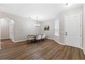Bright dining room featuring wood floors, a chandelier, and neutral decor, perfect for entertaining at 1044 Sw 159Th St, Ocala, FL 34473
