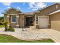 Attractive home with a neatly landscaped front yard, white stone accents, and an inviting entryway at 1044 Sw 159Th St, Ocala, FL 34473