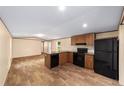 Bright kitchen featuring modern appliances, wood cabinets, and wood-look flooring, creating a welcoming space at 221 Se 167Th Ct, Silver Springs, FL 34488