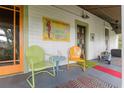 Comfortable front porch featuring vintage-style chairs and a charming aesthetic at 5881 Avenue H, Mc Intosh, FL 32664