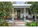 Inviting front porch with seating and decor, offering a relaxing outdoor space at 5881 Avenue H, Mc Intosh, FL 32664