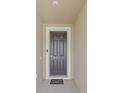 A welcoming entryway with a classic dark-colored front door, framed by white trim and a decorative doormat at 8123 Sw 57Th Ct, Ocala, FL 34476