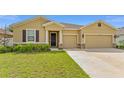 Inviting single-Gathering home with a well-manicured lawn and a two-car garage, showcasing charming exterior details at 8123 Sw 57Th Ct, Ocala, FL 34476