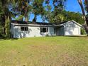 Well-maintained single-story home with a spacious front yard and an attached garage at 11027 Sw 75Th Ave, Ocala, FL 34476
