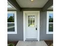 Welcoming front entry featuring a white door with glass panes and bright white trim at 15433 Sw 47Th Avenue Rd, Ocala, FL 34473