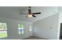 Bright living room with a ceiling fan and a view through two windows at 15433 Sw 47Th Avenue Rd, Ocala, FL 34473