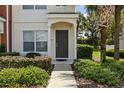 Close-up of a townhome entrance with lush landscaping leading to a welcoming front door at 4426 Sw 49Th Ave, Ocala, FL 34474